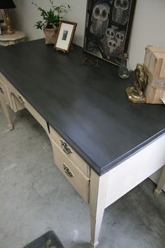 an old desk is painted black and white