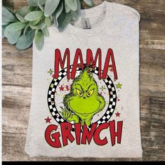 a white shirt with the words mama grin on it and an image of a green monster