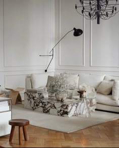 a living room filled with furniture and a chandelier