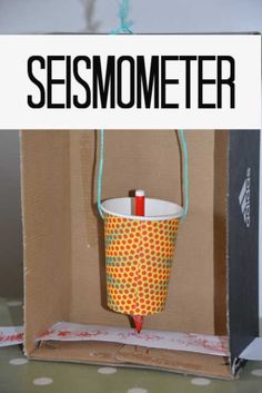 an open box with a string attached to it and the words make your own seismometer