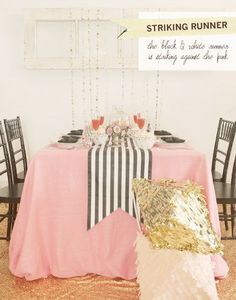 the table is set with black and white striped linens, gold sequins, and pink napkins