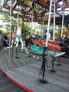 a carousel with horses and people on it