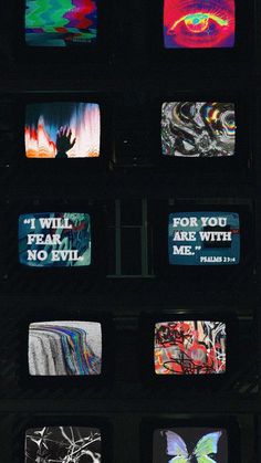 several televisions with different designs on them in a dark room and one is displaying the words for you, fear, are with me