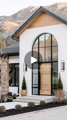 a white house with black trim and arched glass doors is featured in the video, occup modern