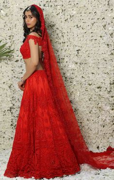 Editor's Note Enveloped Between The Elegance Of French Lace And Shine Of Swarovski Lies Our L'élégant Lehenga. Featuring An Elegant French Lace Lehenga With Red Self-on-self Swarovski Embroidery And Thread Work. It's Paired With A Red French Lace Blouse With Swarovski Highlights To Complete The Look. The Dupatta Is A Trail Dupatta Which Flows Behind The Bride, It's Embroidered With A Beautiful Crystal Lace Border. This Outfit Can Be Customised In Any Colour And With Any Blouse Design. Color: Red Fitted Embroidered Lace Sharara, Red Embroidered Fabric With Sheer Dupatta For Reception, Elegant Red Lehenga For Ceremony, Fitted Lace Lehenga For Festive Occasions, Fitted Lace Lehenga With Embroidery, Embroidered Lace Floor-length Sets, Fitted Bollywood Lehenga In Lace, Red Sets With Pallu For Ceremony, Fitted Lace Lehenga For Festivals