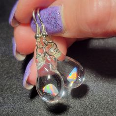 "My friend Marcy named this style of earrings. She said they look like Mermaid's tears. These teardrop dangle earrings are crafted by melting borosilicate glass tubing (pyrex) and blowing a bubble at the end of the tube in the flame, encasing a white Gilson opal nugget inside. The opal flashes with blue, green, yellow, and red hues within the glass. Only first-quality borosilicate glass and a blowtorch fueled by oxygen and propane are used, and the pieces are annealed in a digitally controlled e Glass Teardrop Jewelry With Matching Earrings, Hypoallergenic Sterling Silver Iridescent Jewelry, Glass Drop Earrings With Matching Set, Hypoallergenic Glass Drop Earrings, Hypoallergenic Iridescent Sterling Silver Jewelry, Nickel-free Glass Drop Jewelry, Handmade Teardrop Opal Jewelry, Glass Drop Earrings As Gift, Unique Natural Inclusion Drop Earrings