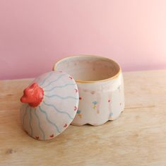 two ceramic bowls sitting on top of a wooden table