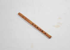 a wooden flute with holes in the middle