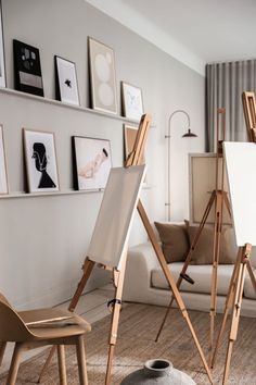 an artist's easel in the middle of a living room