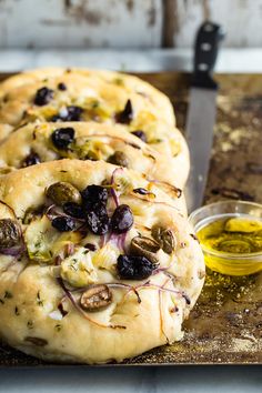 bread with olives and herbs on a cutting board