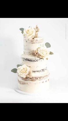 a three tiered cake with white flowers on top