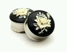 two black and white knobs with flowers on them