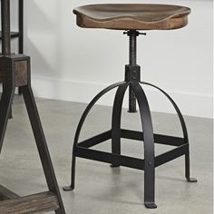 an industrial style bar stool with wooden seat