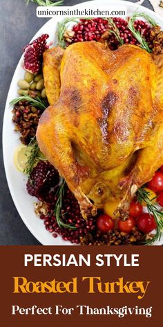 a roasted turkey on a white plate with cranberries and other holiday foods around it