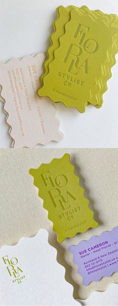 some type of business cards on top of each other with different colors and designs in them