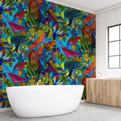 a bath tub sitting in front of a colorful wallpaper