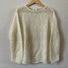 a white sweater hanging on a wall