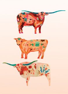 three different colored cows standing next to each other