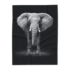 an elephant with tusks is shown in black and white on a throw blanket