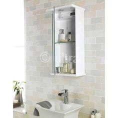 a white sink sitting under a bathroom mirror next to a wall mounted medicine cabinet in a bathroom