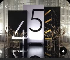 the number five is displayed in front of an artistic display with black and gold accents