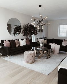 a living room filled with furniture and a chandelier