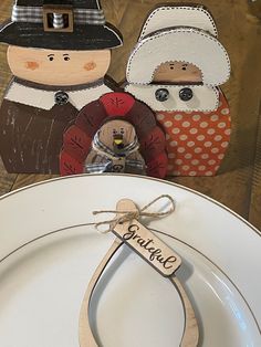 a couple of wooden cutouts sitting on top of a white plate