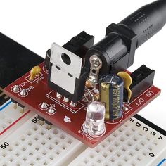 an electronic device is attached to a microcontrole board with soldering tools