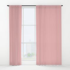 an open window with pink curtains in front of it and a white wall behind it