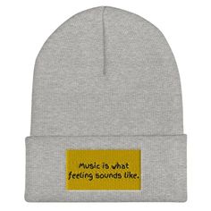 a grey beanie with the outline of africa on it and heartbeats in white