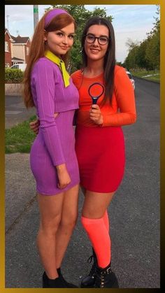 two women dressed in costumes posing for the camera