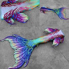 two colorful fish laying on the ground next to each other, one is painted with different colors