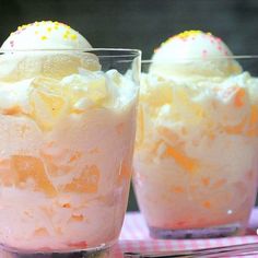 two glasses filled with ice cream on top of a pink and white checkered table cloth