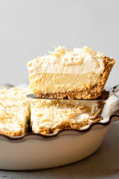 a piece of cheesecake sitting on top of a pie pan with a fork in it