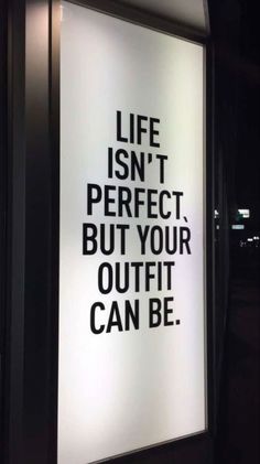 a sign that says life isn't perfect but your outfit can be