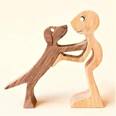 a wooden sculpture of a person holding a dog