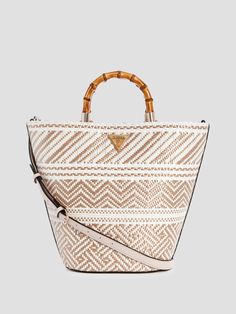 Two-tone woven straw tote bag Smooth faux-leather trim Shiny gold-tone hardware and signature emblem Large trapezoid silhouette Single-compartment construction Interior pocketing Magnetic snap-button closure Bamboo-look top handles with 3.5" drop. Detachable crossbody strap with 19" drop. 14.25"W x 11.25"H x 5.5"D Straw Tote Bag, Guess Bags, Straw Tote, Mini Tote Bag, Mini Tote, White Bag, Handbag Backpack, Womens Tote Bags, Tote Handbags