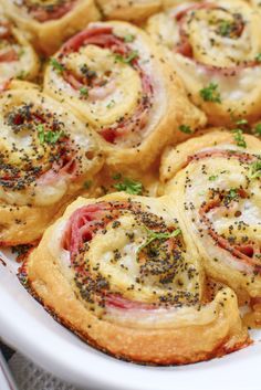 a white plate topped with rolls covered in cheese and toppings