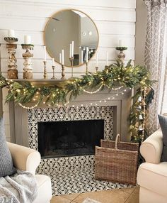 a living room filled with furniture and a fire place covered in christmas garlands next to a mirror