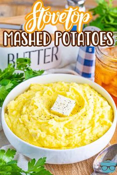 mashed potatoes in a white bowl with butter and parsley on the side text overlay reads slow top mashed potatoes