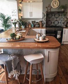 a kitchen island with two stools next to it