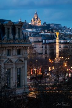 the city is lit up at night and it's lights shine brightly on the buildings