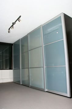 an empty room with large glass doors on the wall