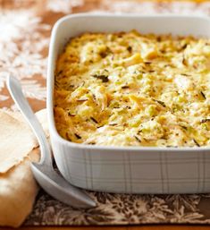 a casserole dish with broccoli and cheese in it on a table