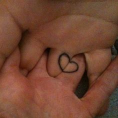 someone holding their hand with a heart tattoo on it