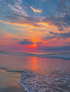 the sun is setting over the water at the beach