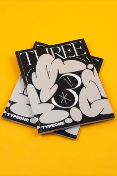 three magazine covers sitting on top of each other with the same logo in black and white