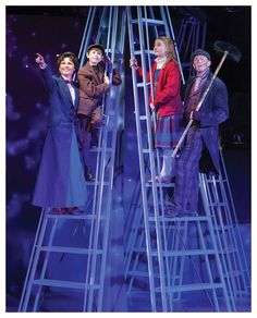 three people standing on top of ladders in front of a purple background with stars