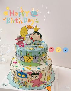 a three tiered cake with cartoon characters on it and the words happy birthday written in large letters