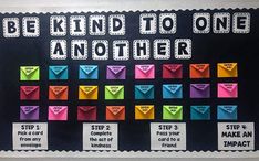 a bulletin board with different colored envelopes and the words be kind to one another